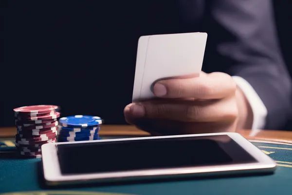 A confident dealer surrounded by casino chips inviting players to access their 4777BIT account, reflecting quick and easy login options.